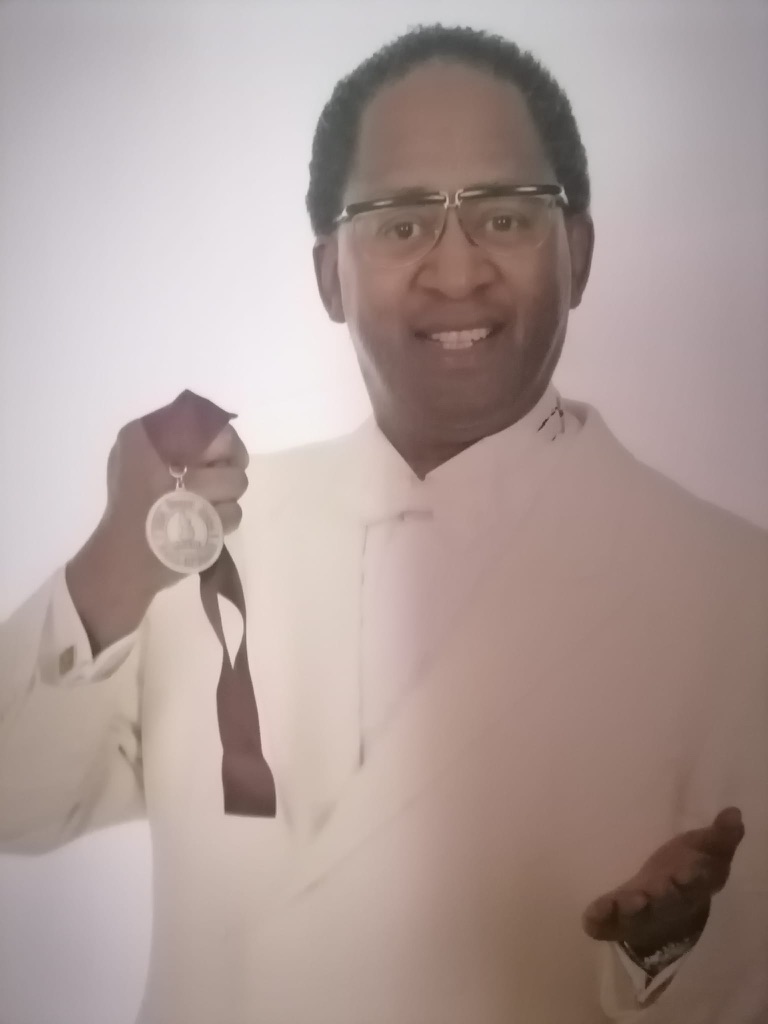 Toni Lorenzo holding his US Gospel Hall of Fame Medal